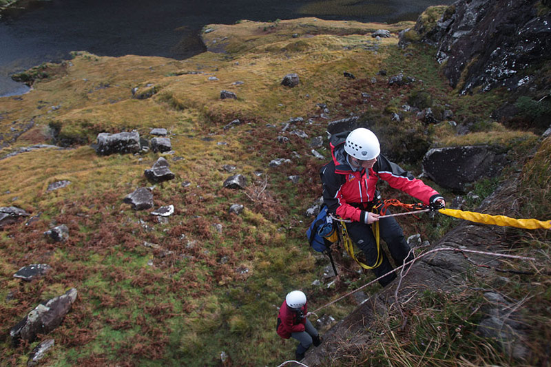 Abseiling to a casual during training.