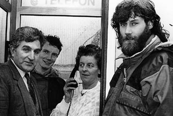 The much awaited installation of a phone box in Cronin's Yard. From left to right, Eddie Cahill (Telecom Eireann District Manager), Kevin Tarrant, Eileen Cronin, Con Moriarty.